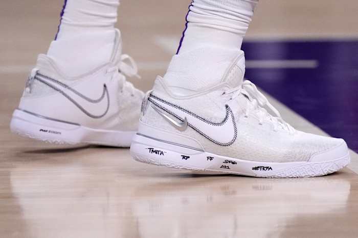 View of LeBron James' white Nike shoes.